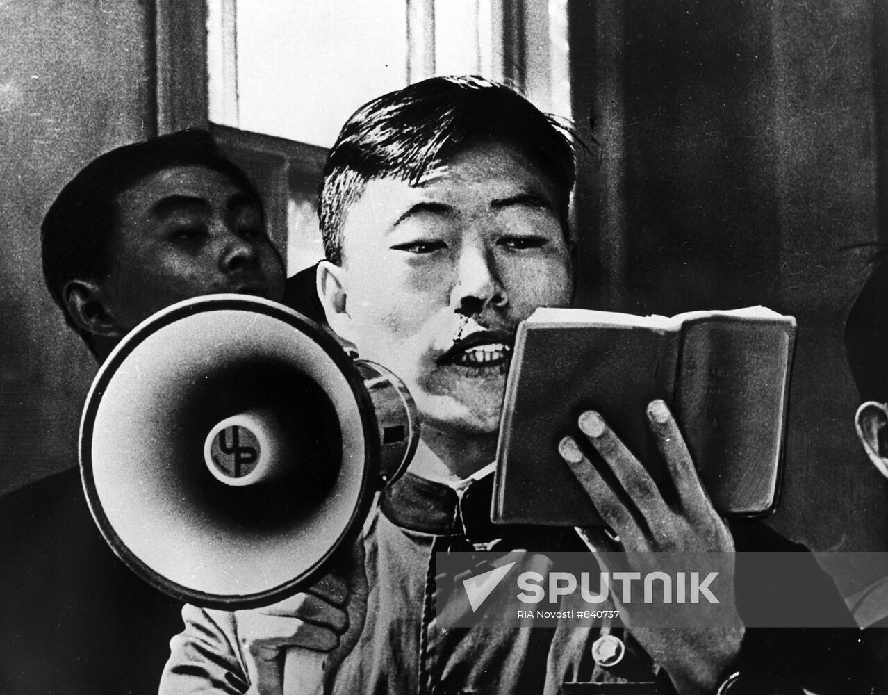 Young man reads Mao Zedong's quotations