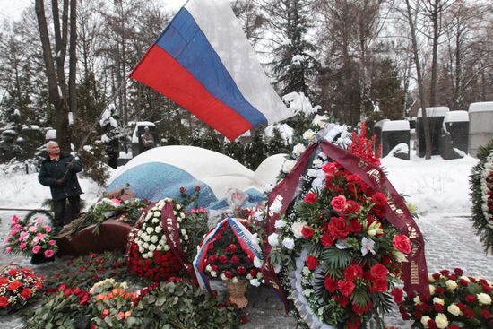 Laying flowers on first Russian President Boris Yeltsin's grave