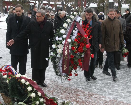 Laying flowers on first Russian President Boris Yeltsin's grave
