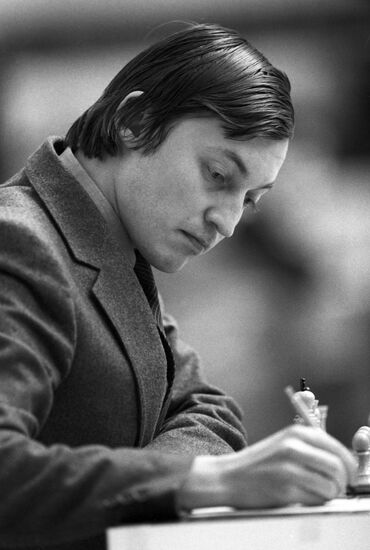 Russian chess grandmasters Boris Spassky, right, and Anatoly Karpov, left,  shake hands the news