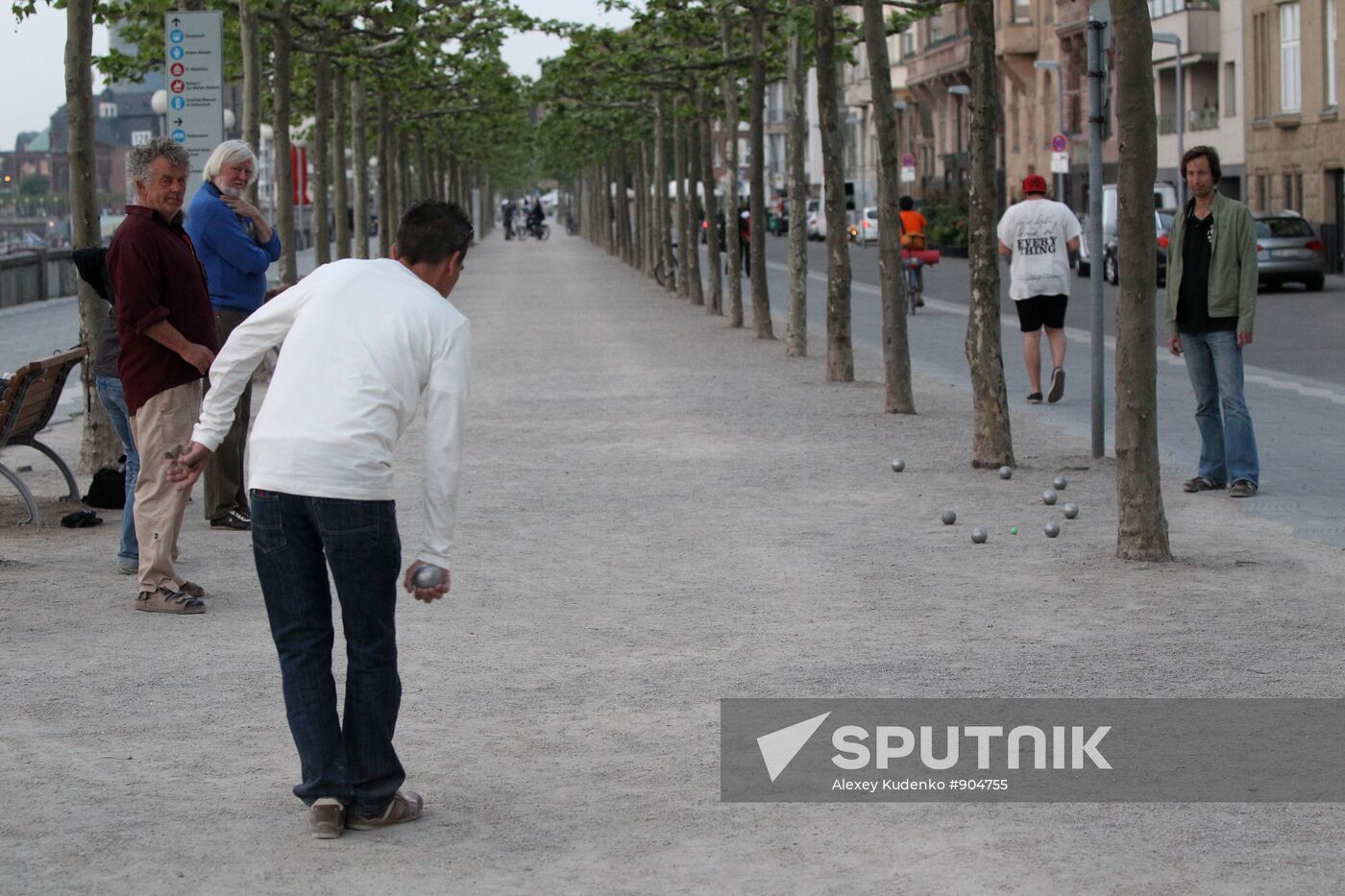 Citizens playing petanque on an embankment in Dusseldorf