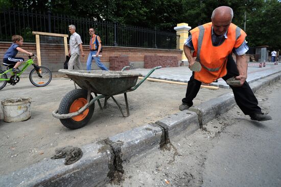 Moscow maintenance workers replace paving stones
