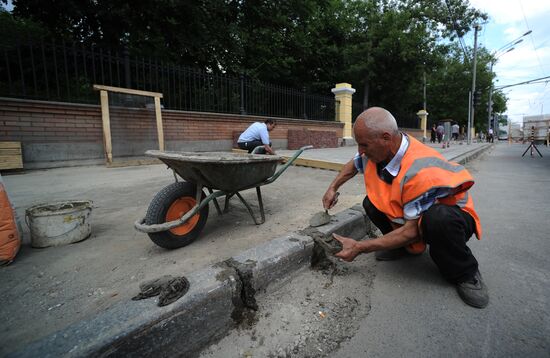 Moscow maintenance workers replace paving stones