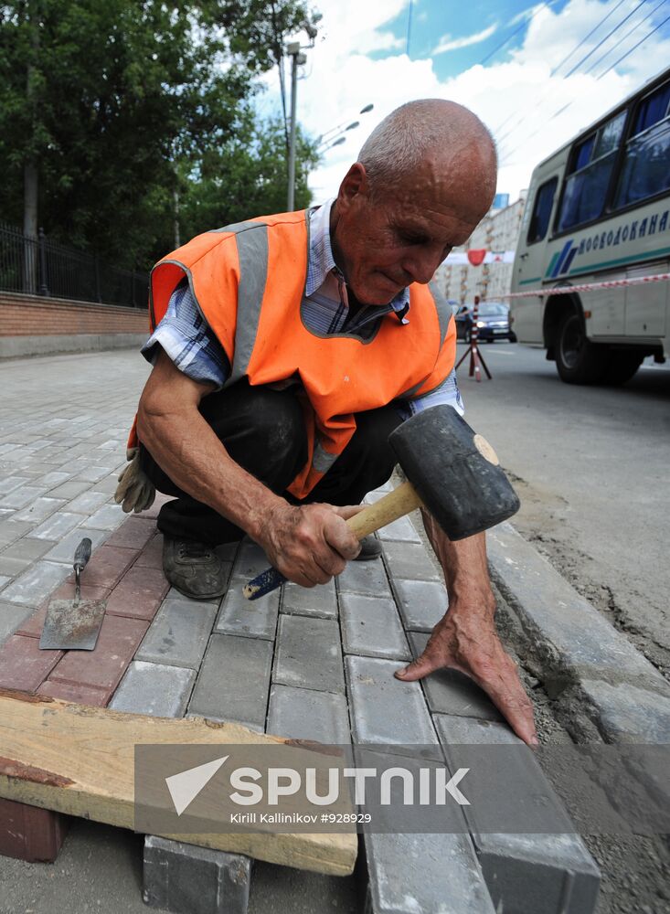 Moscow maintenance workers replace paving stones