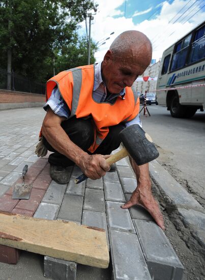 Moscow maintenance workers replace paving stones