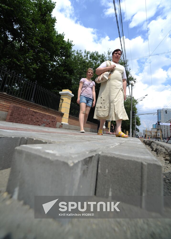 Moscow maintenance workers replace paving stones