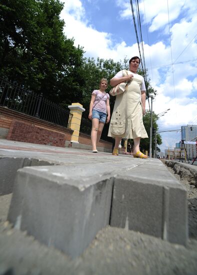 Moscow maintenance workers replace paving stones