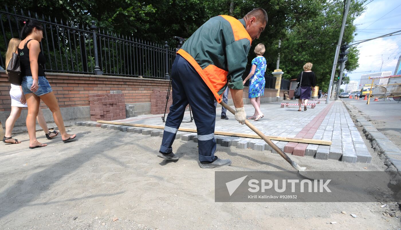 Moscow maintenance workers replace paving stones
