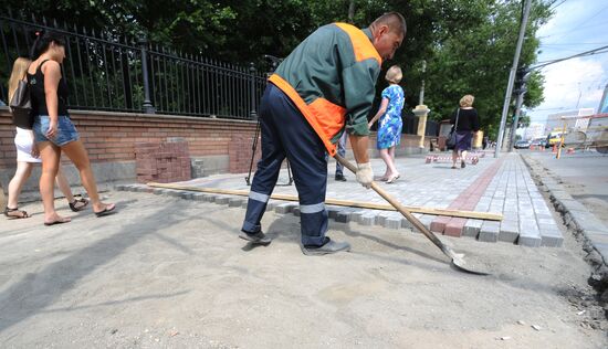 Moscow maintenance workers replace paving stones
