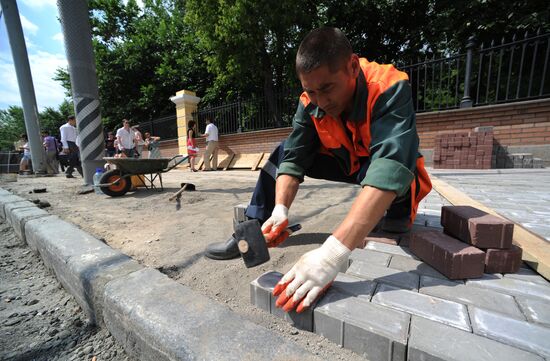 Moscow maintenance workers replace paving stones