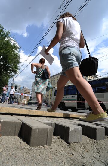 Moscow maintenance workers replace paving stones