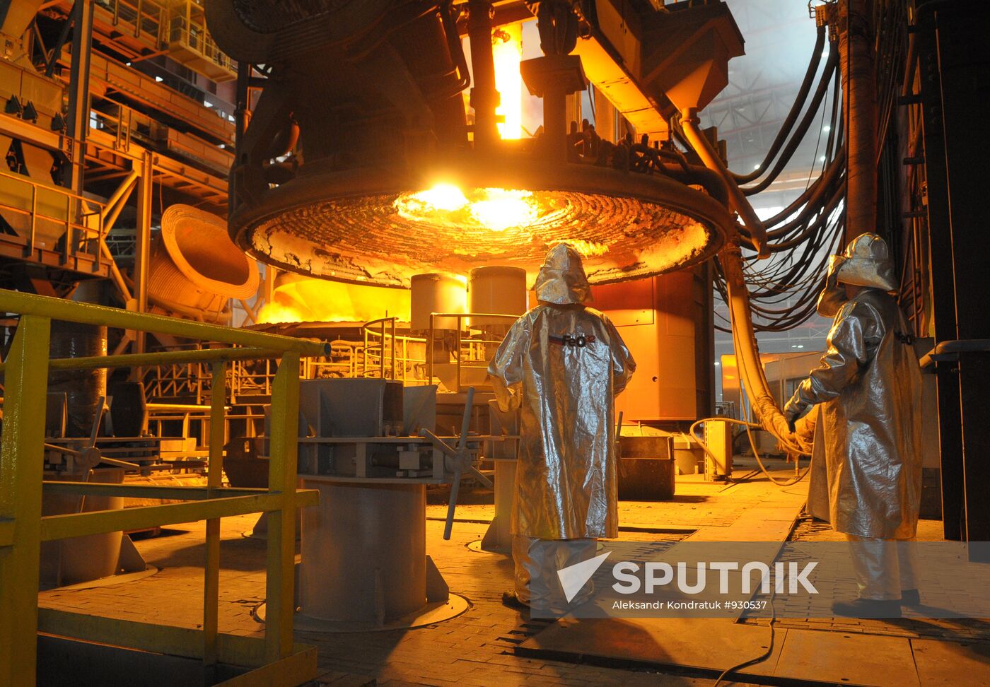 Steelworkers monitor loading of scrap metal