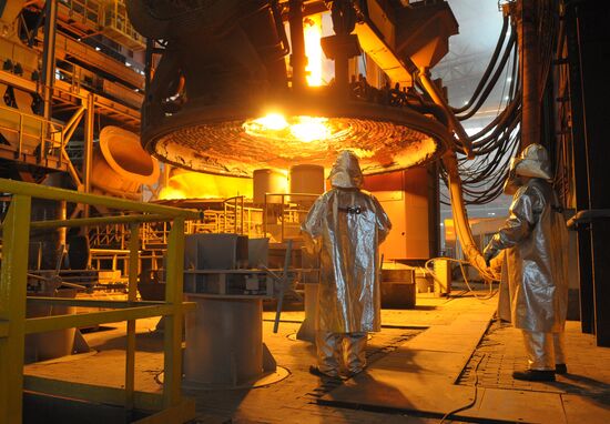 Steelworkers monitor loading of scrap metal
