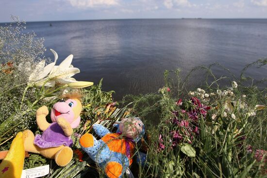 Flowers, toys at pier in village of Zaton named after Kuibyshev