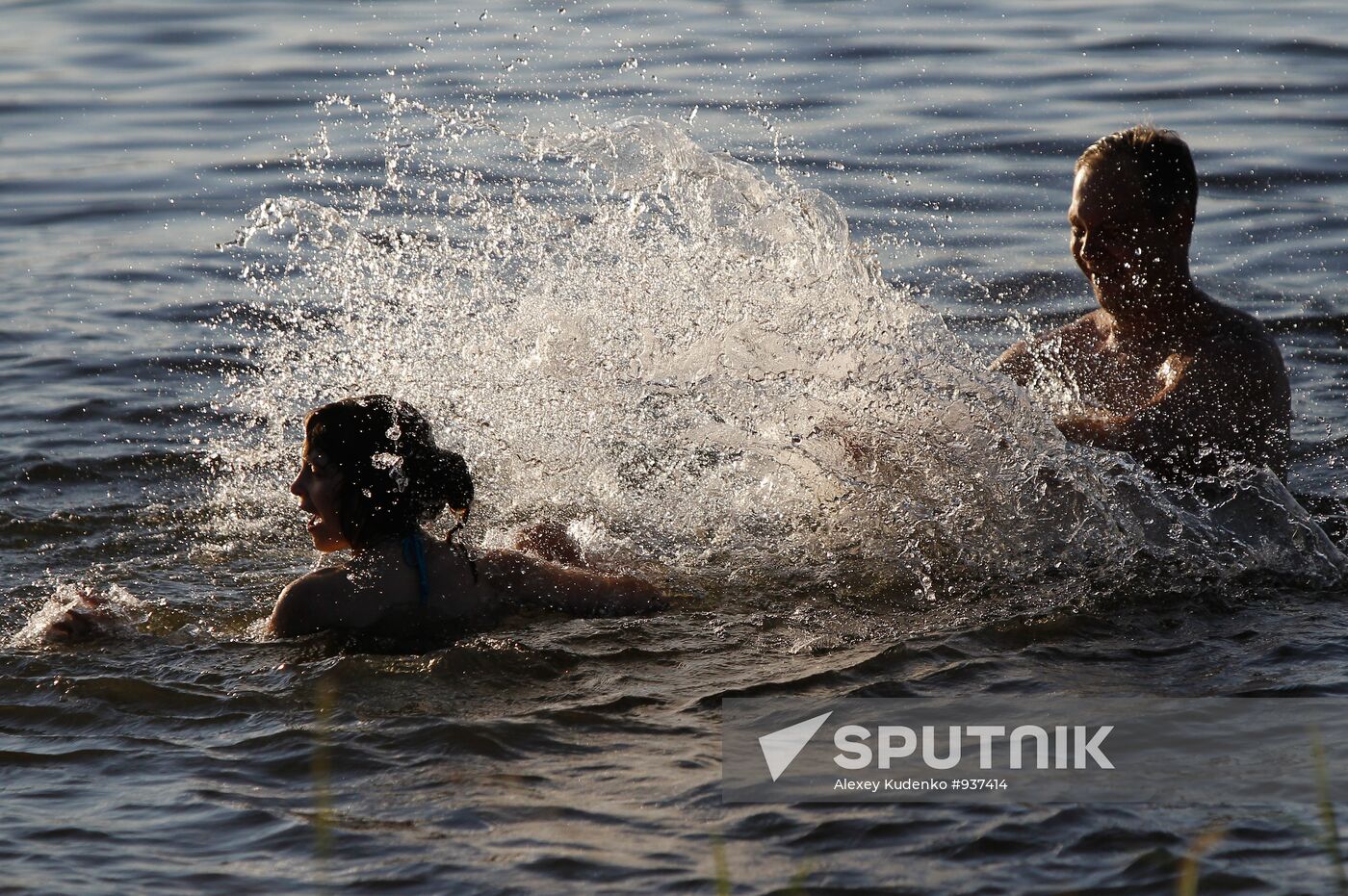 Shuya residents bathe in Teza River