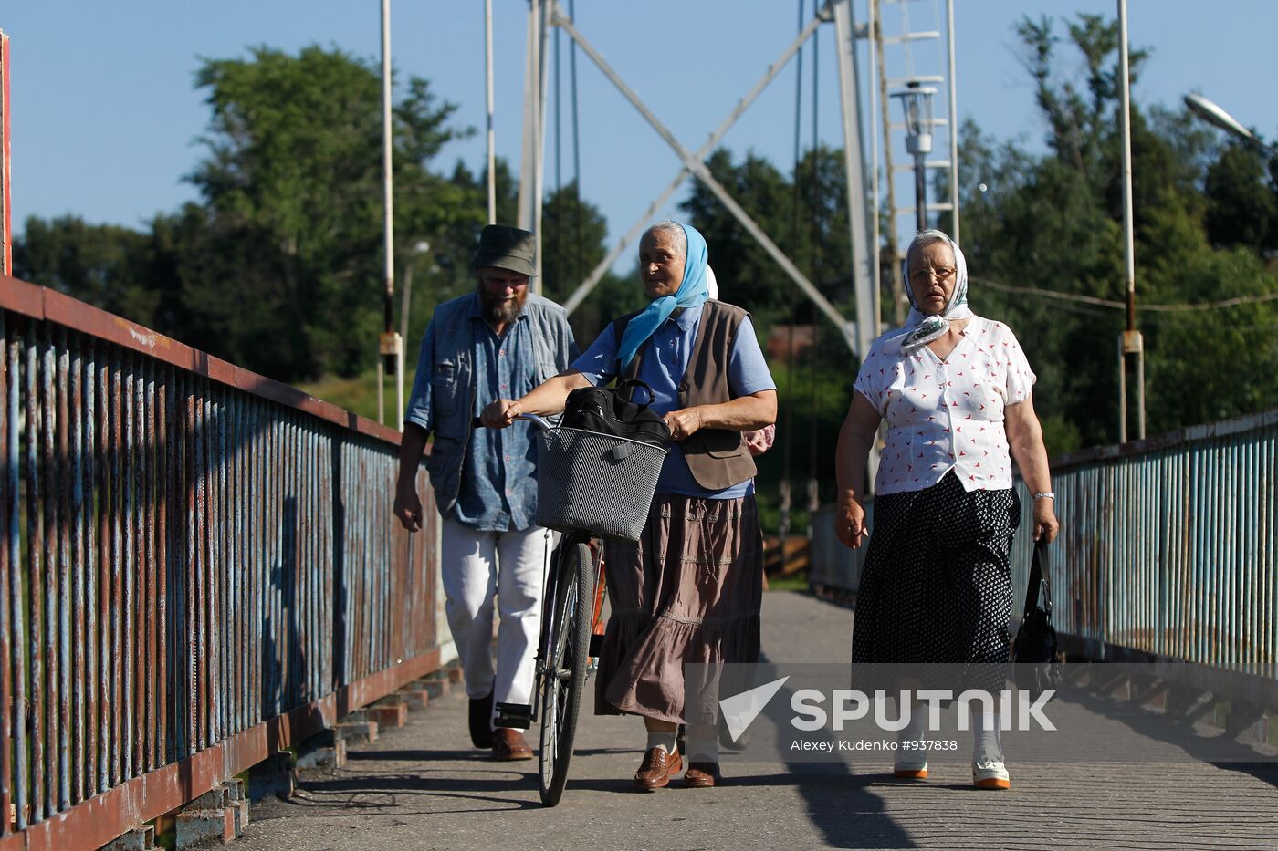 Shuya residents walk on pedestrian bridge over Teza River