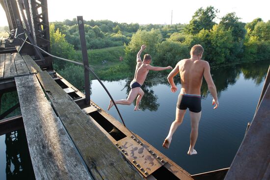 Boys jump off steel railway bridge