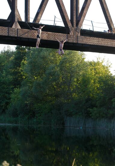 Boys jump off steel railway bridge