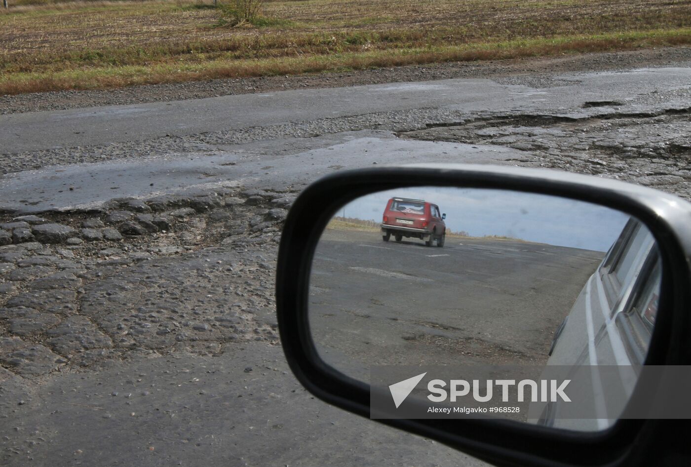 Potholes on road in Omsk region