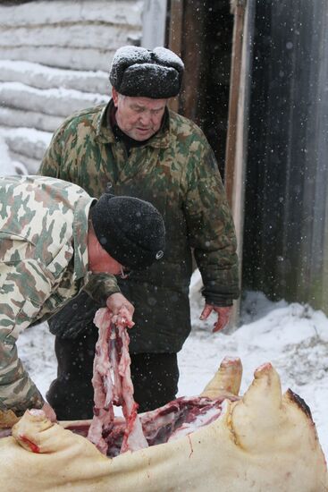 Villagers slaughter a pig before onset of winter