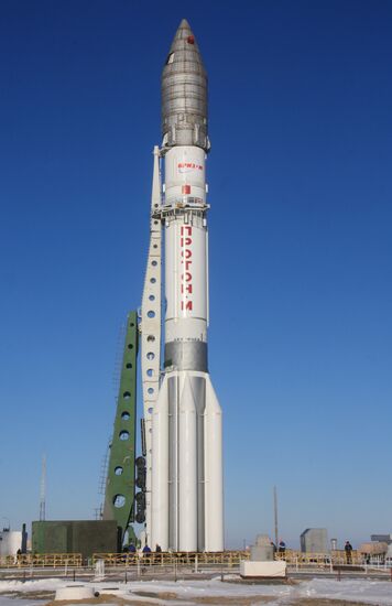 Proton missile with AsiaSat 7 satellite carried to launchpad
