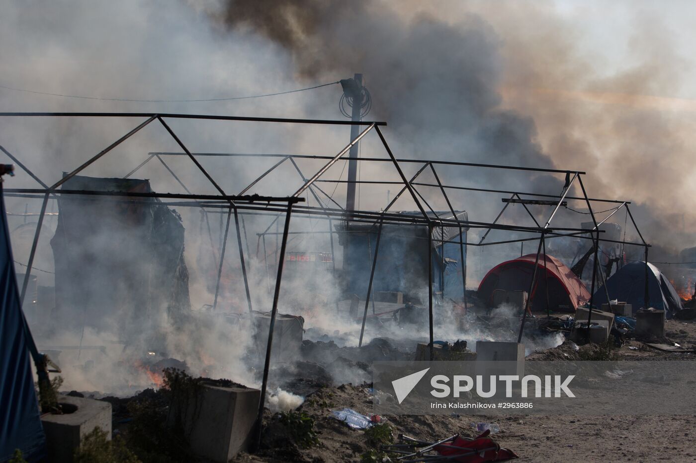 Relocation continues at Jungle spontaneous refugee camp in Calais, France