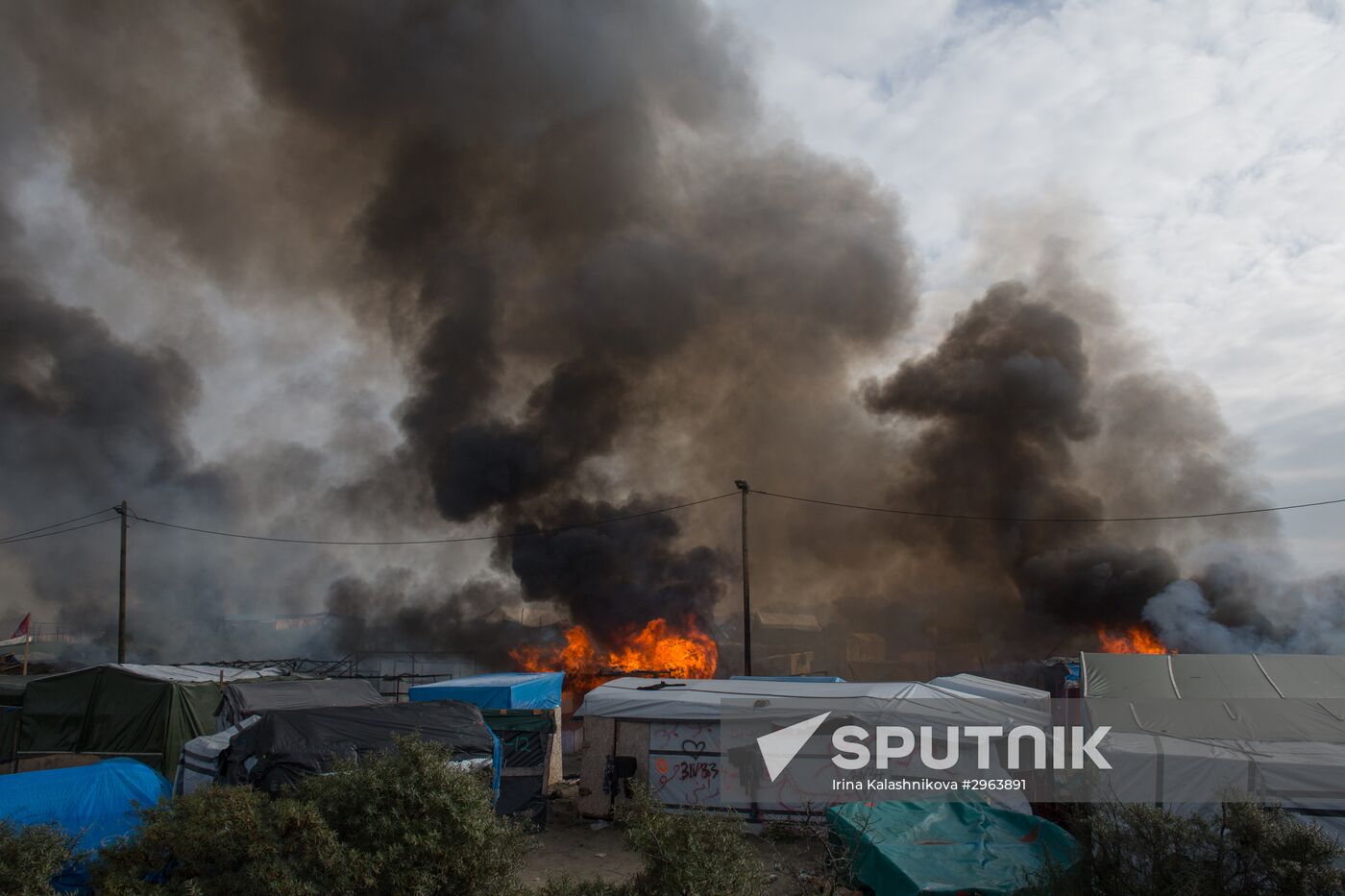 Relocation continues at Jungle spontaneous refugee camp in Calais, France