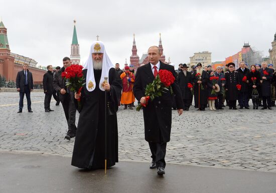 President Vladimir Putin lays flowers at Minin and Pozharsky monument on Red Square
