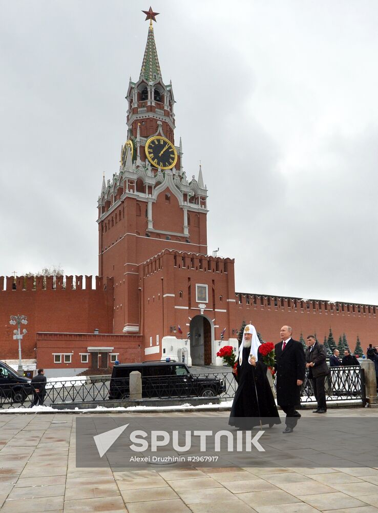 President Vladimir Putin lays flowers at Minin and Pozharsky monument on Red Square