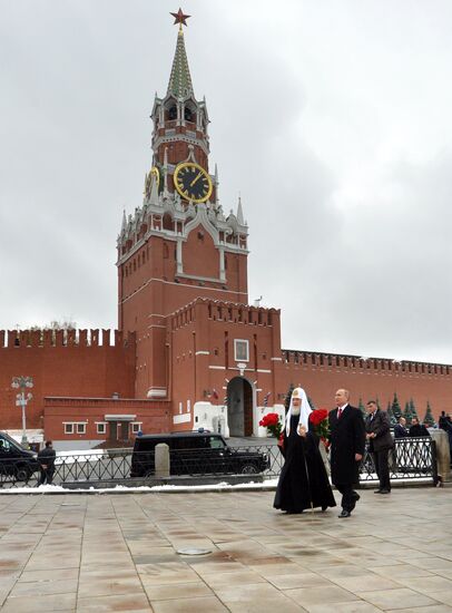 President Vladimir Putin lays flowers at Minin and Pozharsky monument on Red Square