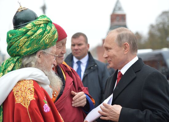 President Vladimir Putin lays flowers at Minin and Pozharsky monument on Red Square