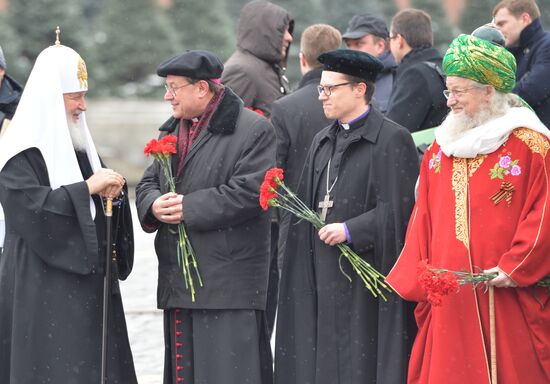 President Vladimir Putin lays flowers at Minin and Pozharsky monument on Red Square