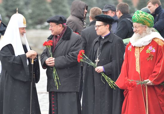 President Vladimir Putin lays flowers at Minin and Pozharsky monument on Red Square