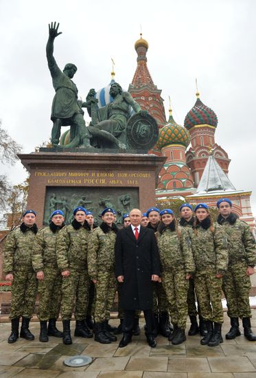 President Vladimir Putin lays flowers at Minin and Pozharsky monument on Red Square