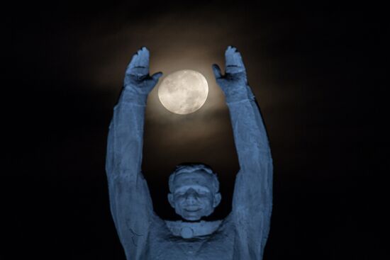 Moon against Yury Gagarin monument in Baikonur