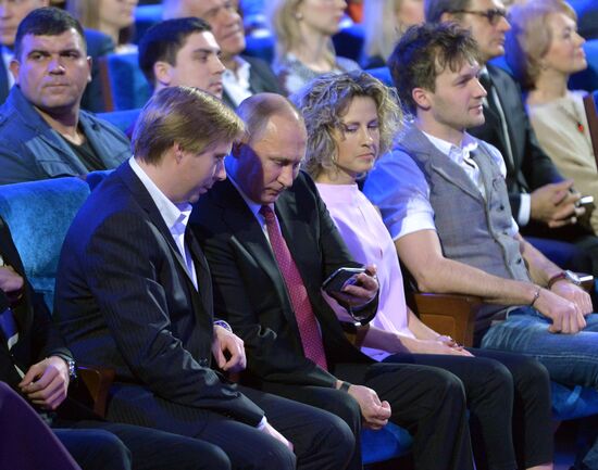 Vladimir Putin at anniversary KVN humor TV game show in Moscow
