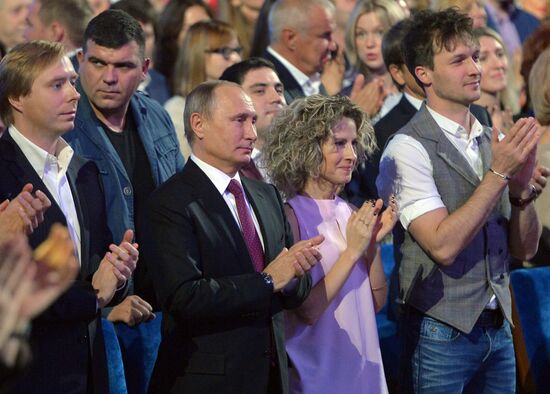 Vladimir Putin at anniversary KVN humor TV game show in Moscow