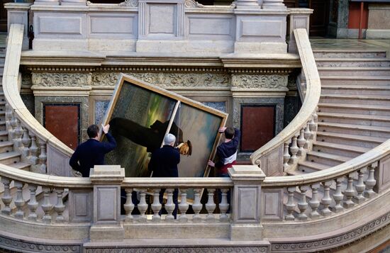 Preparing restored double-sided painting with portraits of Emperor Nicholas II and Vladimir Lenin for presentation at Stieglitz Academy