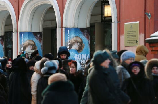 People stand in queue to buy Vatican Pinacotheca exhibition tickets