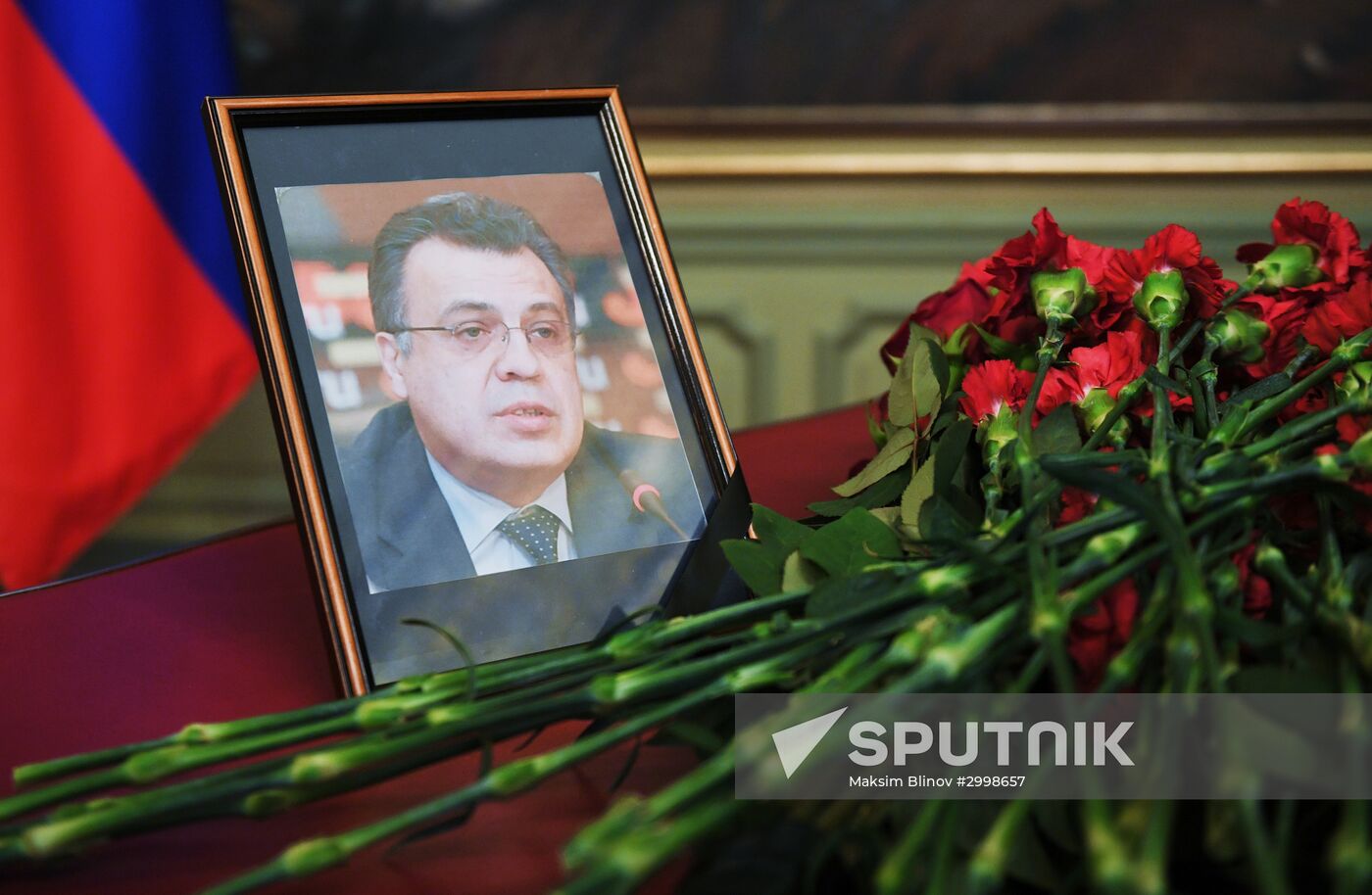 Flowers near portrait of Ambassador Andrei Karlov