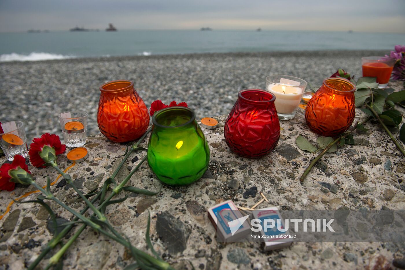 Sochi residents bring Sochi residents bring flowers and candles to Southern Mall Square at Sea Port