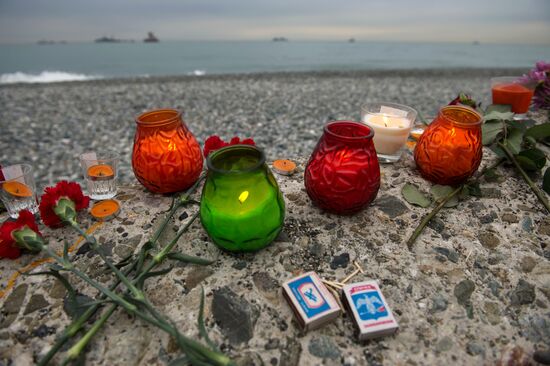 Sochi residents bring Sochi residents bring flowers and candles to Southern Mall Square at Sea Port