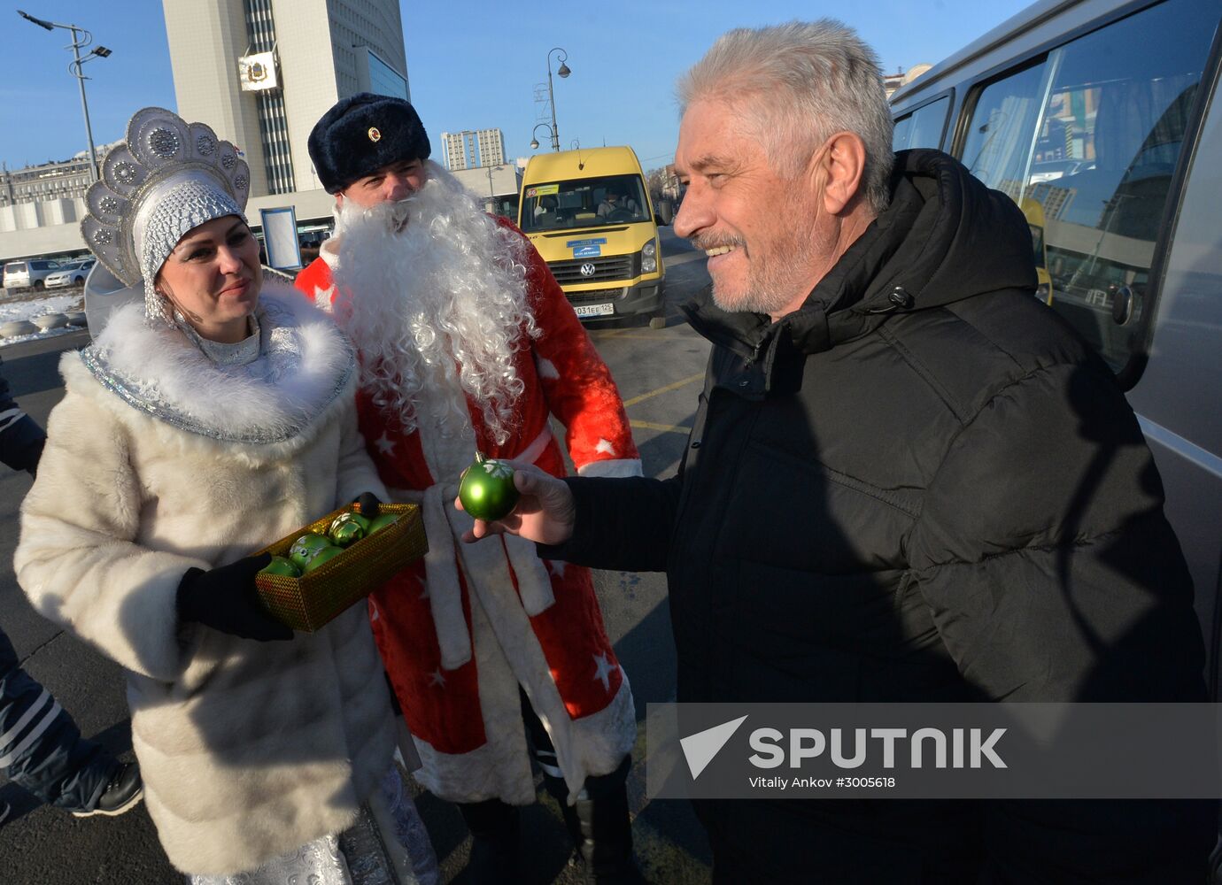 Road police officers in Vladivostok greet drivers and pedestrians dressed up as Father Frost and Snow Maiden