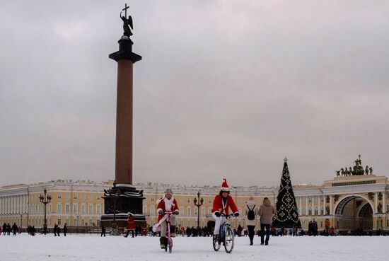 Bicycle parade of Fathers Frost and Snow Maidens in St. Petersburg