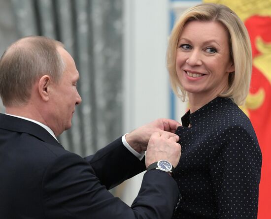 Russian President Vladimir Putin presents state decorations