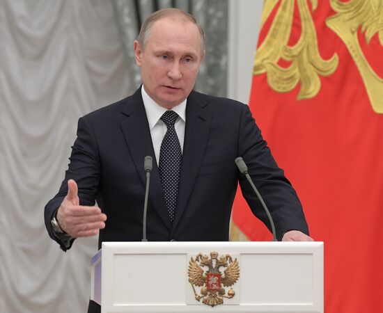 Russian President Vladimir Putin presents state decorations