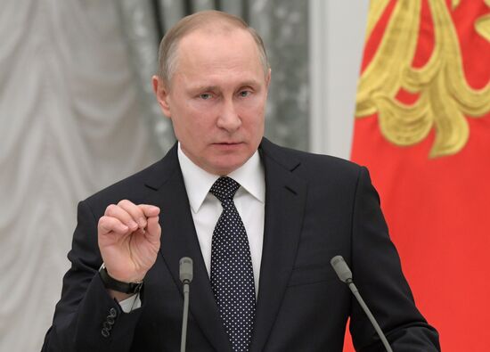 Russian President Vladimir Putin presents state decorations