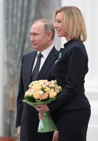 Russian President Vladimir Putin presents state decorations