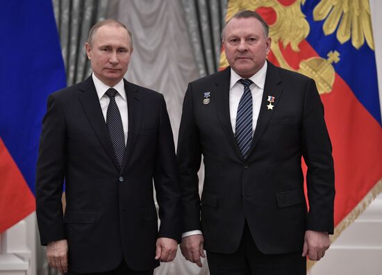 Russian President Vladimir Putin presents state decorations