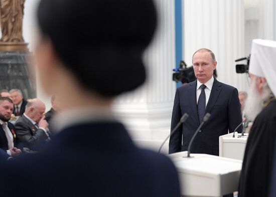 Russian President Vladimir Putin presents state decorations